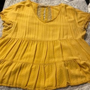 Large, orange/dark yellow, lightweight shirt.